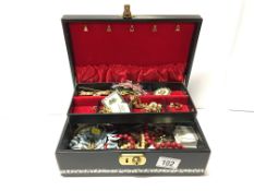 A jewellery box and contents including necklaces,