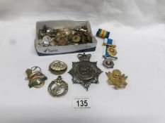 A mixed lot of military badges,