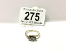 A yellow gold 3 stone diamond cross over ring