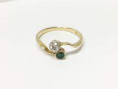 An 18ct gold diamond and emerald cross over ring,