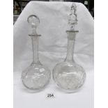 A pair of cut glass decanters (odd stoppers)