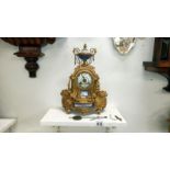 A French gilt mantel clock with enamel dial