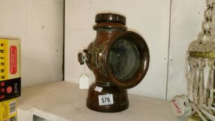 An early 20th century King of the Road car lamp marked Belsize (handle missing and crack to glass)