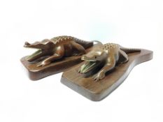 A pair of wooden crocodiles with either bone or ivory teeth