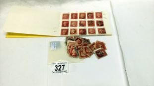 A booklet containing over 100 Victorian British penny red stamps and a packet of over 50 loose