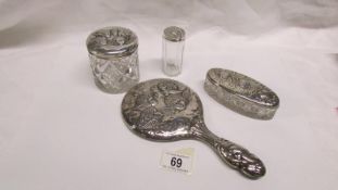 A silver backed hand mirror and 3 silver topped pots all embossed with cherubs, maker W J Myatt,