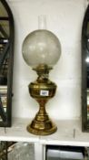 A brass oil lamp with Victorian acid etched shade
