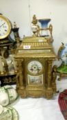 A gilded mantel clock with enamelled dial,