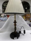 A table lamp being a figure of an Indian doing a handstand,