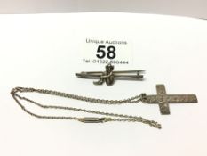 A silver cross on chain and a Lincoln Imp brooch