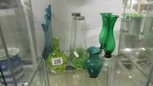 A quantity of green glass vases