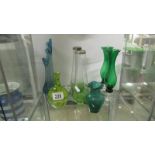 A quantity of green glass vases