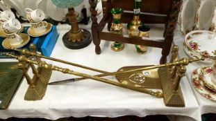 A set of Victorian brass fire irons and fire dogs