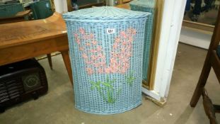 A painted wicker linen bin