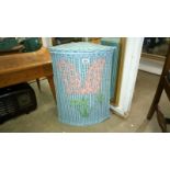 A painted wicker linen bin