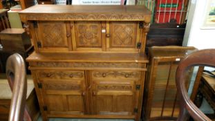 A carved oak court cupboard