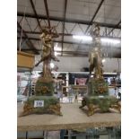 A pair of French gilded figures on marble bases (possibly clock side pieces)