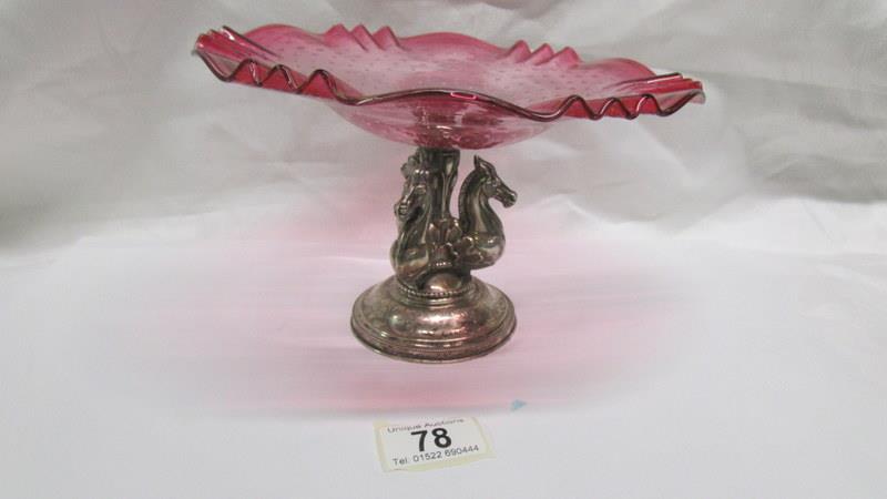A continental silver based comport with 3 horse heads and cranberry glass dish