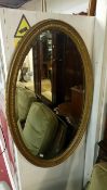 A Victorian/Edwardian oval gilt framed bevel edged mirror