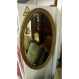 A Victorian/Edwardian oval gilt framed bevel edged mirror