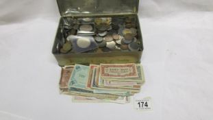 A tin of British and foreign coins and bank notes