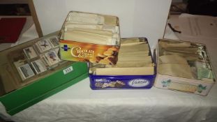 A quantity of cigarette cards in albums and loose in 3 tins and a box