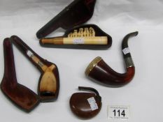 3 smoker's pipes including silver mount and a cigar holder with dog figures and bells