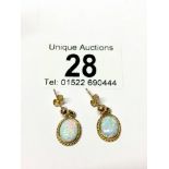 A pair of yellow gold opal earrings