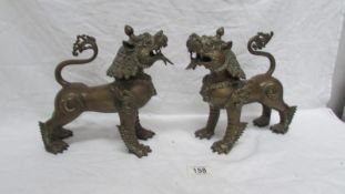 A pair of bronze incense burners in the form of Dogs of Foo