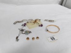 A box of jewellery including gold brooches, enamel pendant,