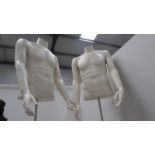 A pair of male torso mannequins