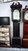 A 19th Century carved dark oak 8 day Grandfather clock by M.