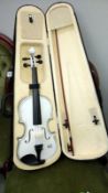 A modern white violin with bow with digital tuner and case