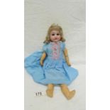 A 19th century bisque headed doll with composition body, marking on neck indeciferable