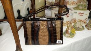 A snake skin hand bag