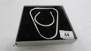 A matching silver necklace and bracelet