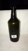 An early stone glass bottle with seal of a hand and letters HC