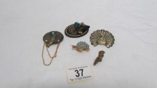 4 brooches and one other item