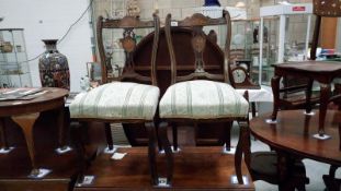 A pair of ornate Edwardian inlaid mahogany chairs