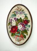 An oval framed wool work picture