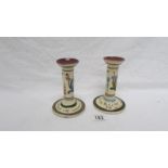 A pair of Torquay motto ware candlesticks