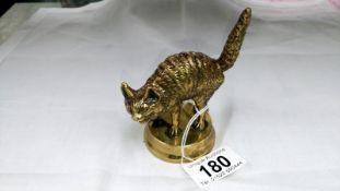 A brass cat paperweight