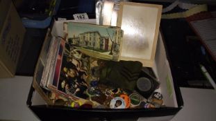 A mixed lot including postcards, badges, penknives etc