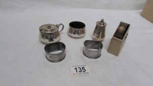 A silver 3 piece condiment set and 3 silver napkin rings