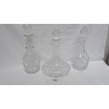 A cut glass ships decanter and 2 others