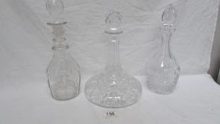 A cut glass ships decanter and 2 others