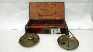 A cased set of Avery brass apothecary scales