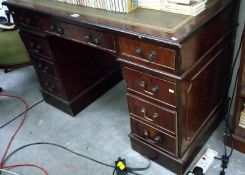 A darkwood stained double pedestal desk with green leather insert