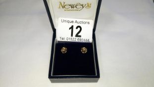 A pair of 9ct gold studs