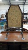 A Victorian mahogany fire screen with a tapestry insert